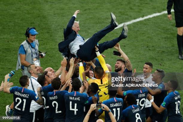 France's coach Didier Deschamps celebrates with his team players at the end of the Russia 2018 World Cup final football match between France and...