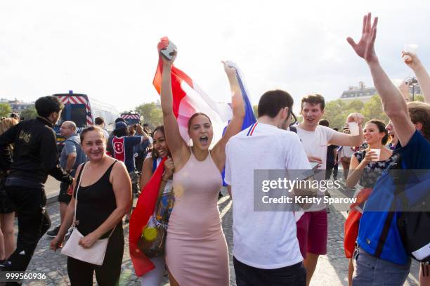 French fans gather on the Arc de Triomphe to celebrate the victory of France over Croatia 4-2 during the World Cup on July 15, 2018 in Paris, France.