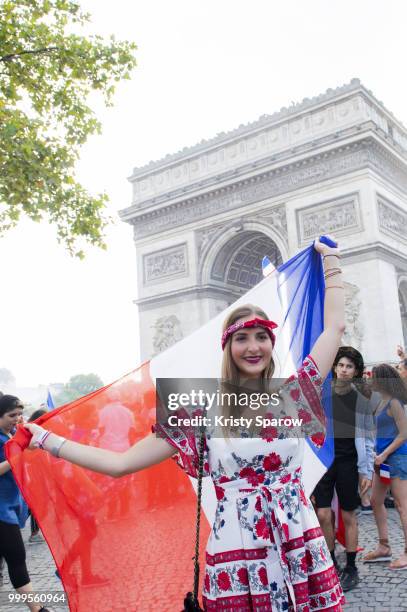 French fans gather on the Arc de Triomphe to celebrate the victory of France over Croatia 4-2 during the World Cup on July 15, 2018 in Paris, France.