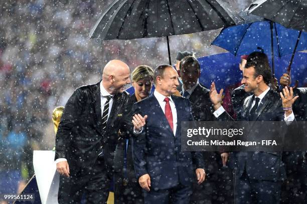 President Gianni Infantino, President of Russia Vladimir Putin and French President Emmanuel Macron chat on the stage following the 2018 FIFA World...