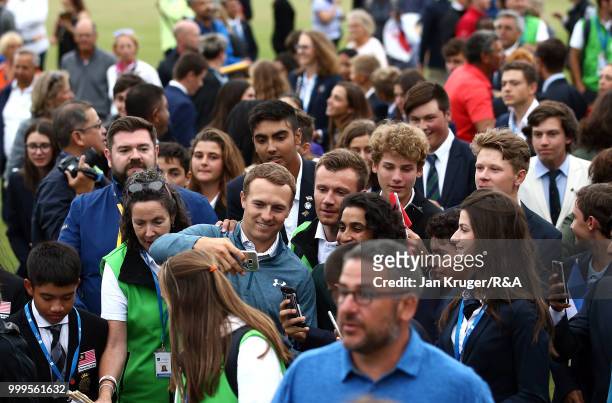Open Champion Jordan Spieth of United States of America has a selfie taken with players during the Junior Open Championship opening ceremony at The...