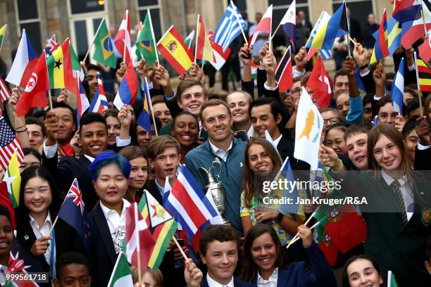 Open Champion Jordan Spieth of United States of America poses with junior players during the Junior Open Championship opening ceremony at The Old...