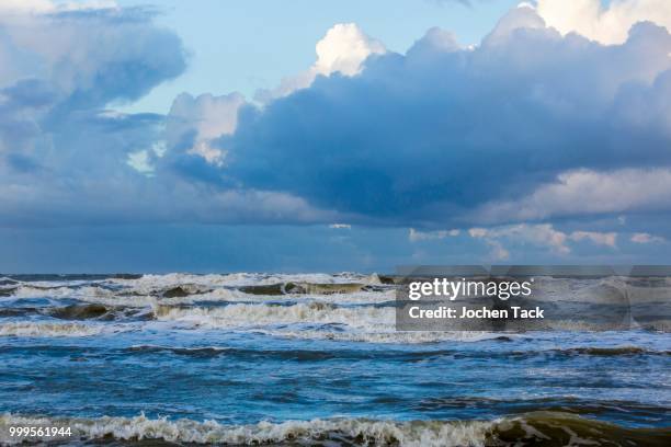 north sea beach, stormy sea, dark clouds during an autumn storm, de haan, flanders, belgium - haan stock pictures, royalty-free photos & images