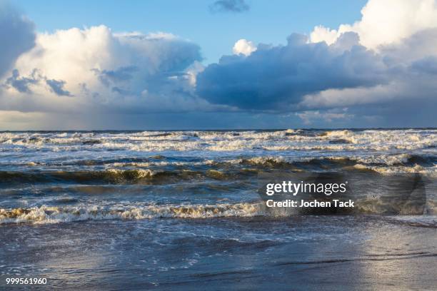 north sea beach, stormy sea, dark clouds during an autumn storm, de haan, flanders, belgium - haan stock pictures, royalty-free photos & images