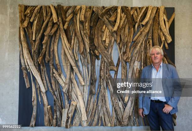 The artist Lois Wagner stands next to his wooden objects at the exhibition "The Tree as Art Work" at the Waelderhaus in Hamburg, Germany, 1 September...