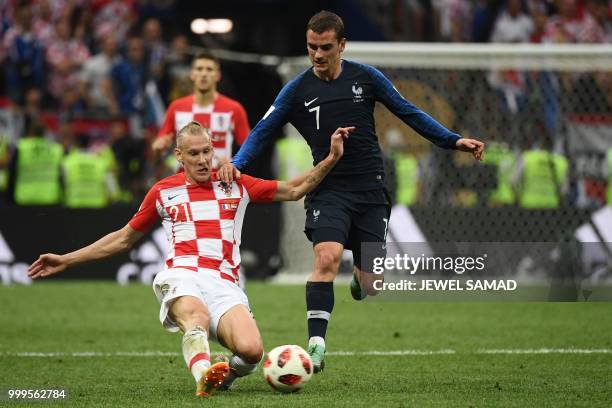 Croatia's defender Domagoj Vida vies for the ball with France's forward Antoine Griezmann during the Russia 2018 World Cup final football match...