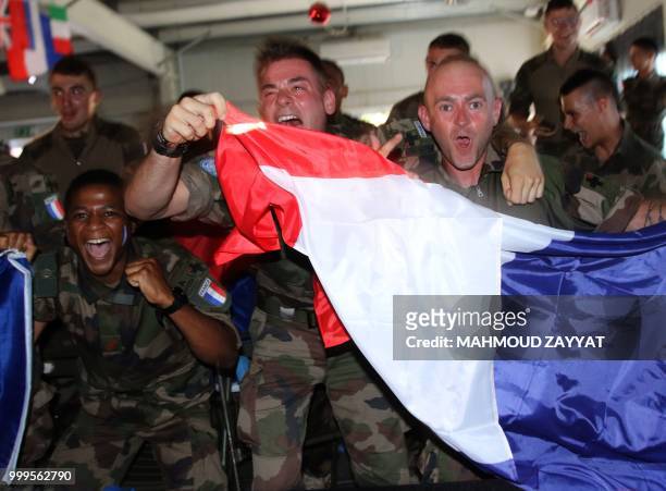 French soldiers from UN Interim Force in Lebanon wave their national flags and cheer for their team while watching the World Cup 2018 final match...