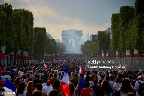 French fans gather along the Champs Elysees to celebrate the France's victory over Croatia in the 2018 FIFA World Cup final on July 15, 2018 in...