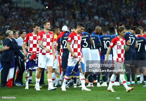 Duje Caleta-Car, Dejan Lovren and Luka Modric of Croatia look dejected during the 2018 FIFA World Cup Final between France and Croatia at Luzhniki...