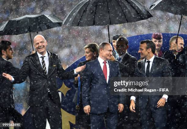 President Gianni Infantino, President of Russia Vladimir Putin and French President Emmanuel Macron chat on the stage following the 2018 FIFA World...