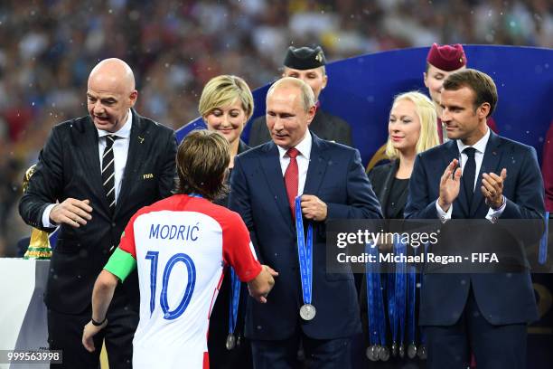 President of Russia Vladimir Putin presents Luka Modric of Croatia with his medal next to FIFA president Gianni Infantino and French President...