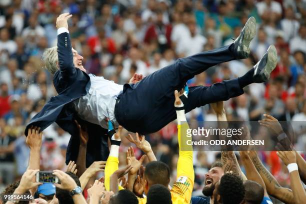 France's coach Didier Deschamps is thrown in the air after the final whistle of the Russia 2018 World Cup final football match between France and...
