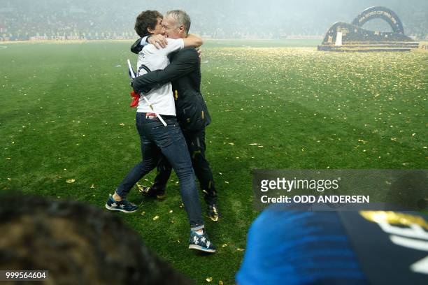 France's coach Didier Deschamps celebrates with his son Dylan after the Russia 2018 World Cup final football match between France and Croatia at the...