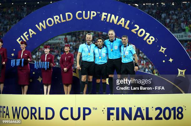 Fourth official Bjorn Kuipers, Assistant referee Juan Pablo Belatti, Referee Nestor Pitana and Assistant referee Hernan Maidana pose with the medals...