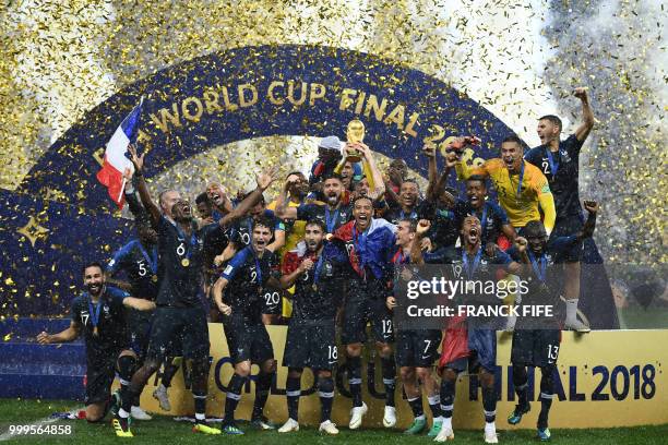 France's players hold their World Cup trophy as they celebrate their win during the trophy ceremony at the end of the Russia 2018 World Cup final...