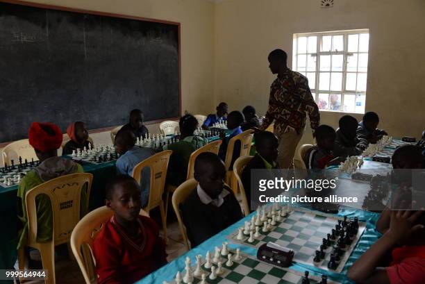 Robert Katende, the leader of the Som Chess Academy in Uganda, giving directions during a chess tournament in Mukuru kwa Njenga, a slum of Nairobi ,...