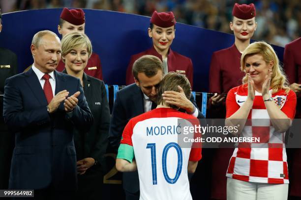 Russian President Vladimir Putin French President Emmanuel Macron and Croatian President Kolinda Grabar-Kitarovic congratulate Croatia's midfielder...