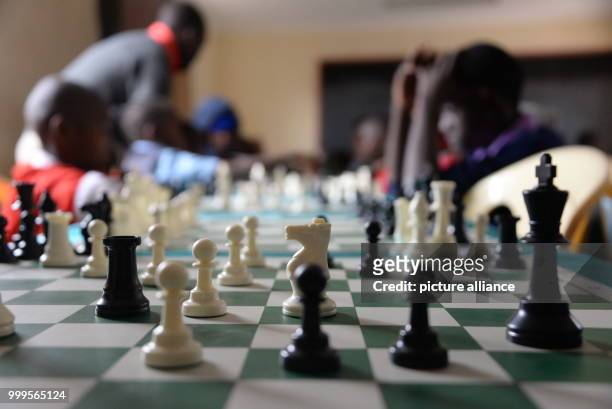 Young Kenyans playing chess during a tournament in Mukuru kwa Njenga, a slum of Nairobi , 15 July 2017. Adolescent Ugandans are also particpating in...