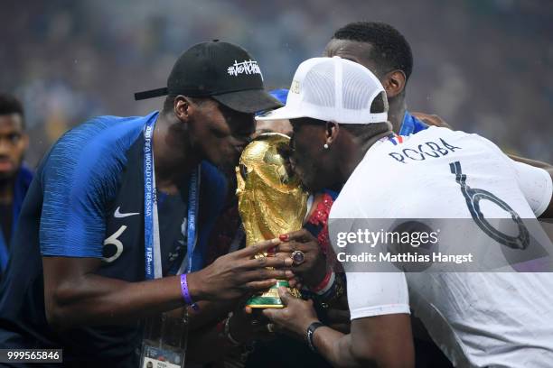 Paul Pogba of France's brother, Florentin Pogba, and Mathias Pogba celebrate with the World Cup Trophy following France's victory in the 2018 FIFA...