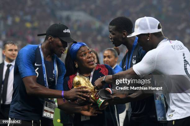 Paul Pogba of France and family; brothers Florentin Pogba, and Mathias Pogba, and mother Yeo Pogba, celebrate with the World Cup Trophy following...