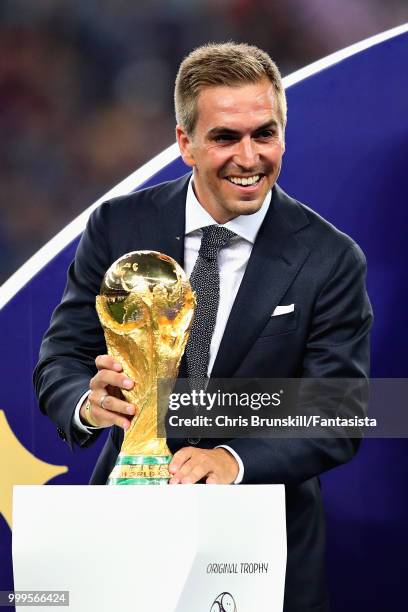 World Cup winner Philipp Lahm puts the World Cup trophy onto the plinth for the presentation after the 2018 FIFA World Cup Russia Final between...