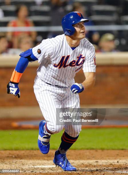 Brandon Nimmo of the New York Mets watches as he runs up the first base line after hitting a game winning walk off home run in the 10th inning in an...