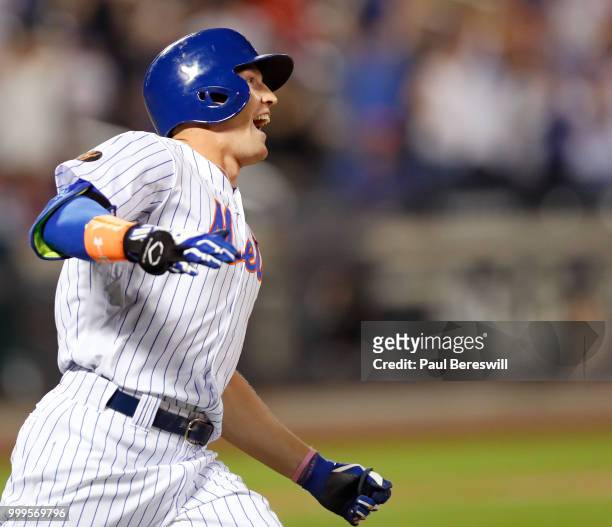Brandon Nimmo of the New York Mets celebrates as he runs up the first base line after hitting a game winning walk off home run in the 10th inning in...