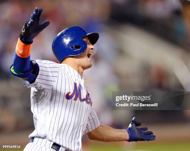 Brandon Nimmo of the New York Mets celebrates as he runs up the first base line after hitting a game winning walk off home run in the 10th inning in...