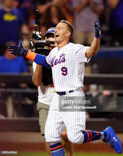 Brandon Nimmo of the New York Mets celebrates as he runs home after hitting a game winning walk off home run in the 10th inning in an MLB baseball...