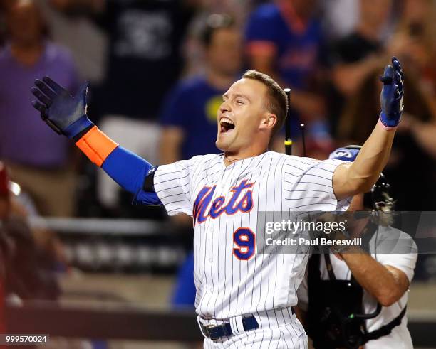 Brandon Nimmo of the New York Mets celebrates as he runs home after hitting a game winning walk off home run in the 10th inning in an MLB baseball...