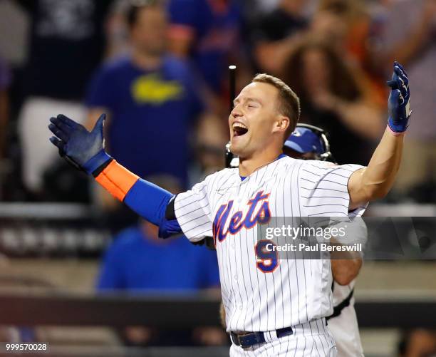 Brandon Nimmo of the New York Mets celebrates as he runs home after hitting a game winning walk off home run in the 10th inning in an MLB baseball...