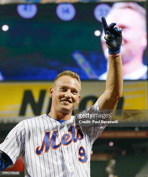 Brandon Nimmo of the New York Mets waves the the crowd after hitting a game winning walk off home run in the 10th inning in an MLB baseball game...