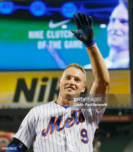 Brandon Nimmo of the New York Mets waves the the crowd after hitting a game winning walk off home run in the 10th inning in an MLB baseball game...