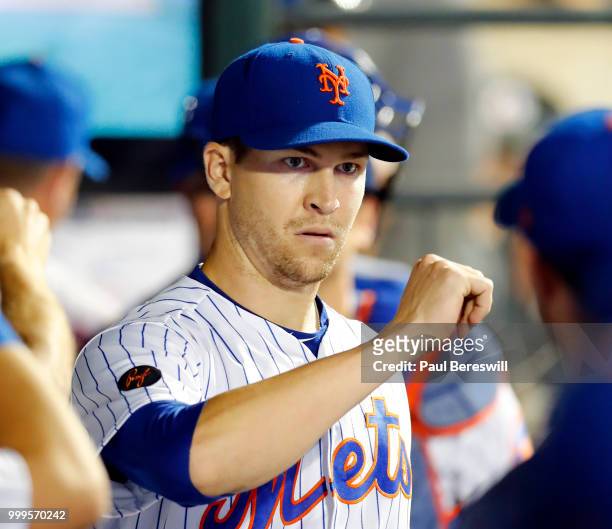 Jacob deGrom of the New York Mets gets congratulations from teammates in the dugout after pitching in the 8th inning in an MLB baseball game against...