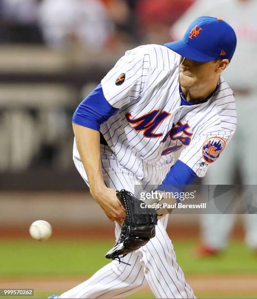 Pitcher Jacob deGrom of the New York Mets comes off the mound to catch a hard line drive by Andrew Knapp of the Philadelphia Phillies to end the...