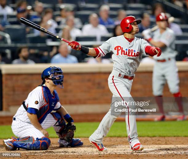 Cesar Hernandez of the Philadelphia Phillies hits a long fly ball in an MLB baseball game against the New York Mets on July 11, 2018 at Citi Field in...