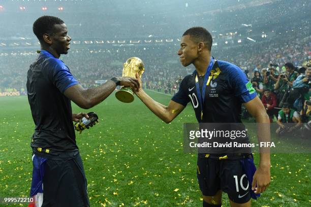 Paul Pogba and Kylian Mbappe of France celebrate victory with the World Cup trophy following the 2018 FIFA World Cup Final between France and Croatia...