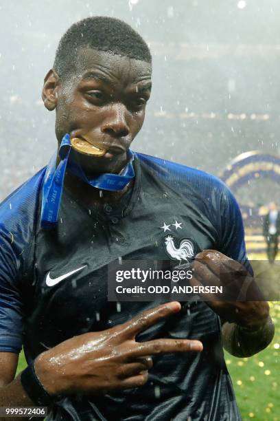 France's midfielder Paul Pogba celebrates with his medal after the Russia 2018 World Cup final football match between France and Croatia at the...