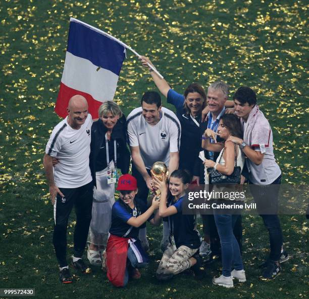 Didier Deschamps, Manager of France, Guy Stephan, France Assistant Coach, and France Goalkeeping Coach, Franck Raviot, celebrate with their families...