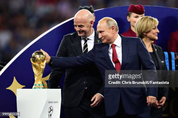 President of Russia Vladimir Putin touches the World Cup trophy after the 2018 FIFA World Cup Russia Final between France and Croatia at Luzhniki...