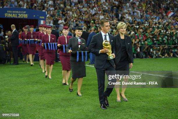 Philipp Lahm walks the World Cup Trophy onto the pitch following the 2018 FIFA World Cup Final between France and Croatia at Luzhniki Stadium on July...