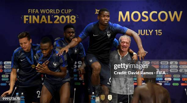 France players celebrate with Didier Deschamps, Manager of France during the press conference after the 2018 FIFA World Cup Final between France and...