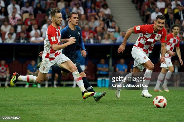 Antoine Griezmann of France is pursuit by Ivan Rakitic and Dejan Lovren of Croatia during the 2018 FIFA World Cup Russia Final between France and...