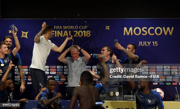 France players celebrate with Didier Deschamps, Manager of France during the press conference after the 2018 FIFA World Cup Final between France and...
