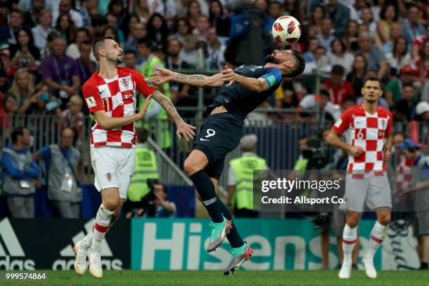 Olivier Giroud of France competes for the ball with Marcelo Brozovic of Croatia during the 2018 FIFA World Cup Russia Final between France and...