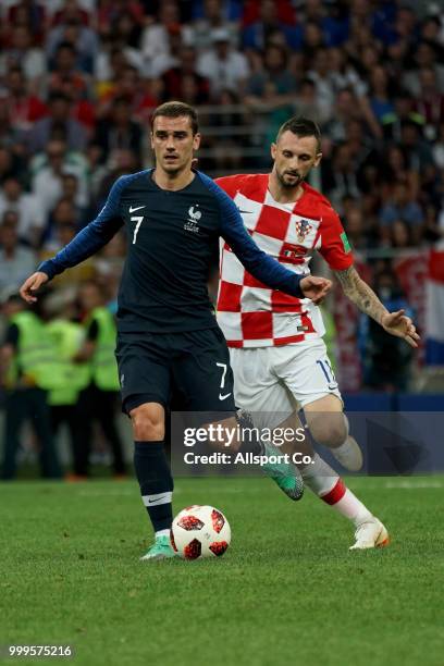 Ivan Strinic of Croatia competes for the ball with Antoine Griezmann of France during the 2018 FIFA World Cup Russia Final between France and Croatia...
