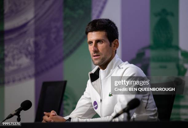 Serbia's Novak Djokovic takes part in a press conference following his men's singles victory on the thirteenth day of the 2018 Wimbledon...