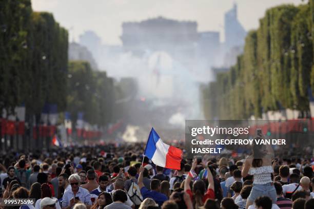 France supporters celebrate on the Champs-Elysees avenue in Paris on July 15 after France won the Russia 2018 World Cup final football match between...