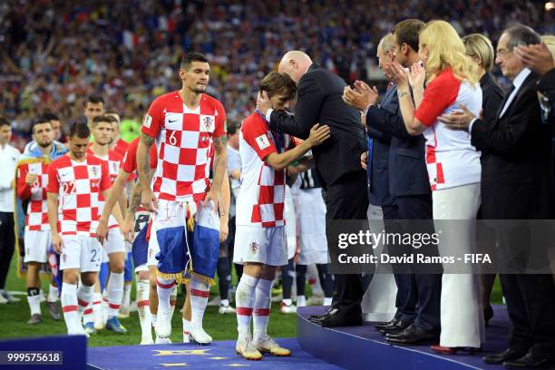 President Gianni Infantino congratulates Luka Modric of Croatia following the 2018 FIFA World Cup Final between France and Croatia at Luzhniki...