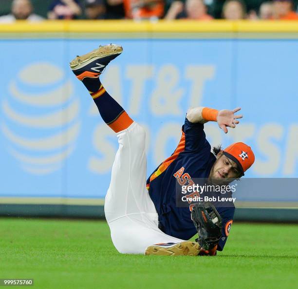Josh Reddick of the Houston Astros makes a diving catch on a line drive by JaCoby Jones of the Detroit Tigers in the third inning at Minute Maid Park...